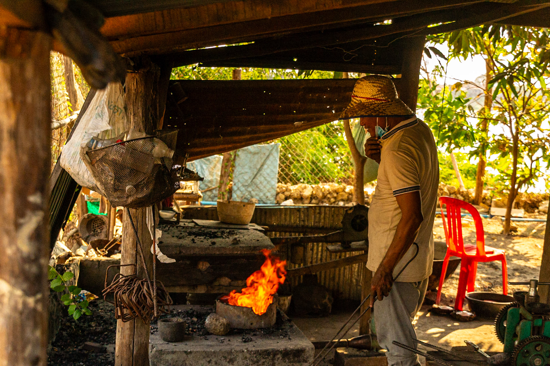 Firing up the forge flames to melt scrap silver.