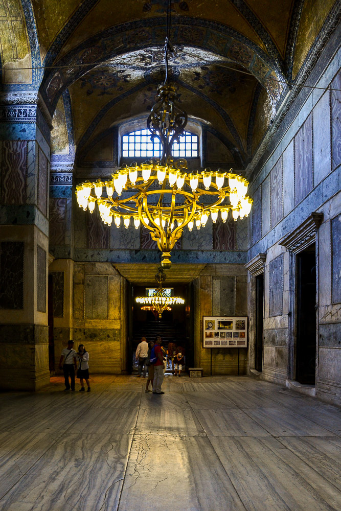 Impressive chandilers light the dark interior spaces.