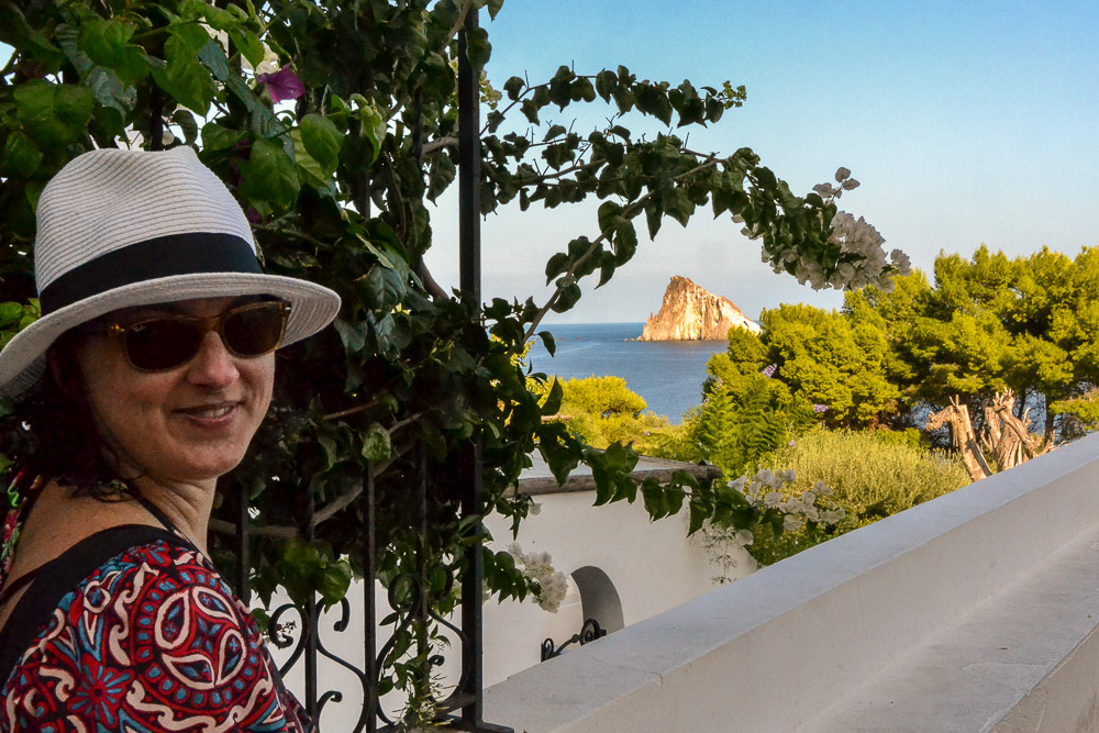 Tracy striking a pose in a picturesque island setting.