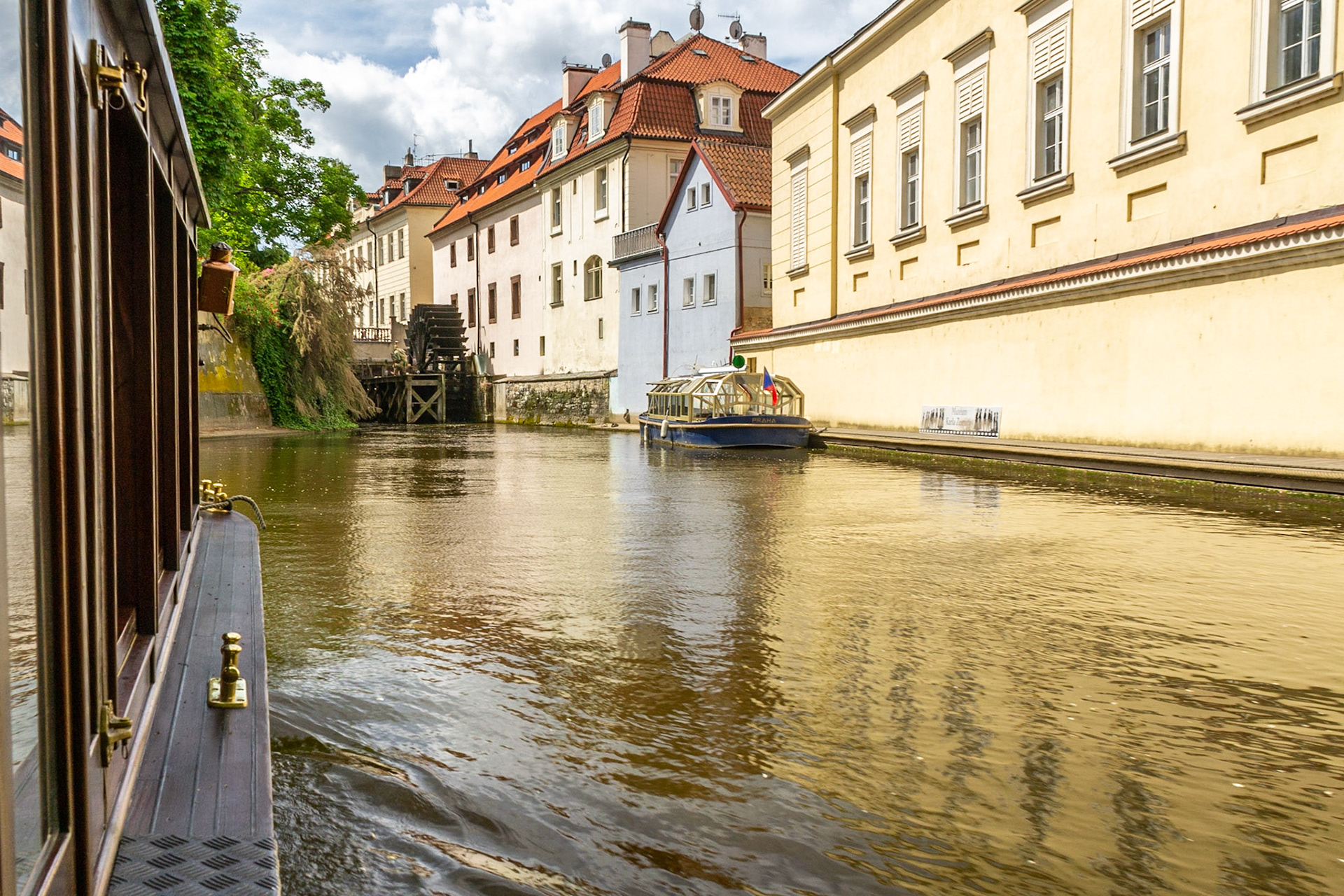 Cruising the canals off the Vltava River - ahead an ancient water-wheel