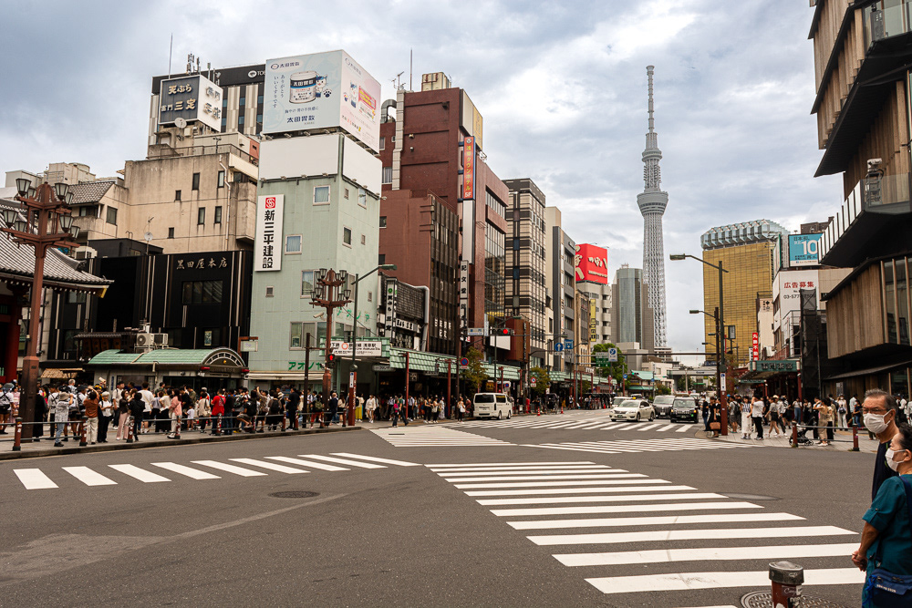 Asakusa district of Tokyo's shitamachi (or low city) at the pedestrian crossing leading to the Sensoji Buddist temple. Tokyo Tower looms in the background.