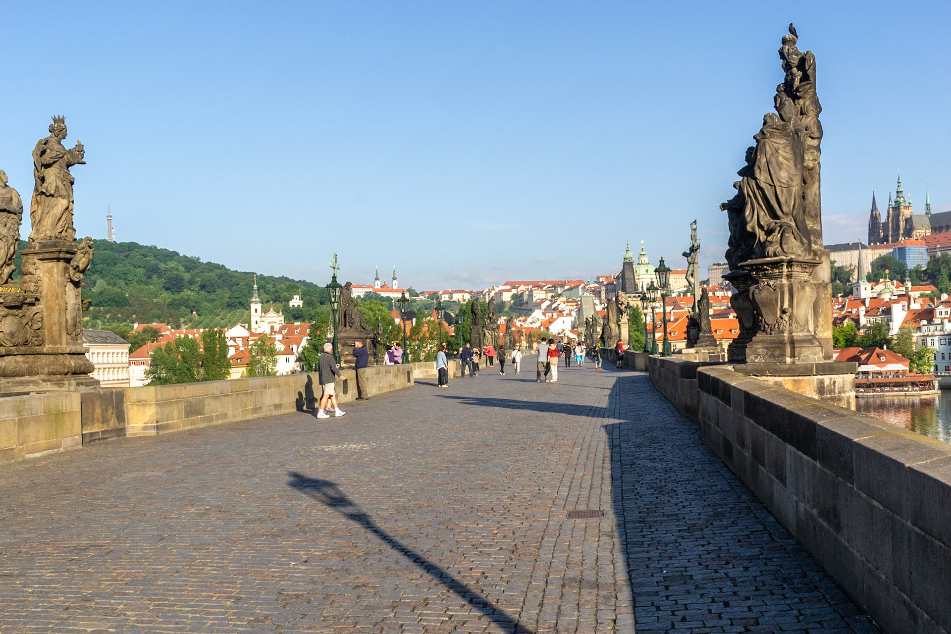 Charles Bridge looking west. The alley of baroque statues was installed on the pillars in the 18th Century.