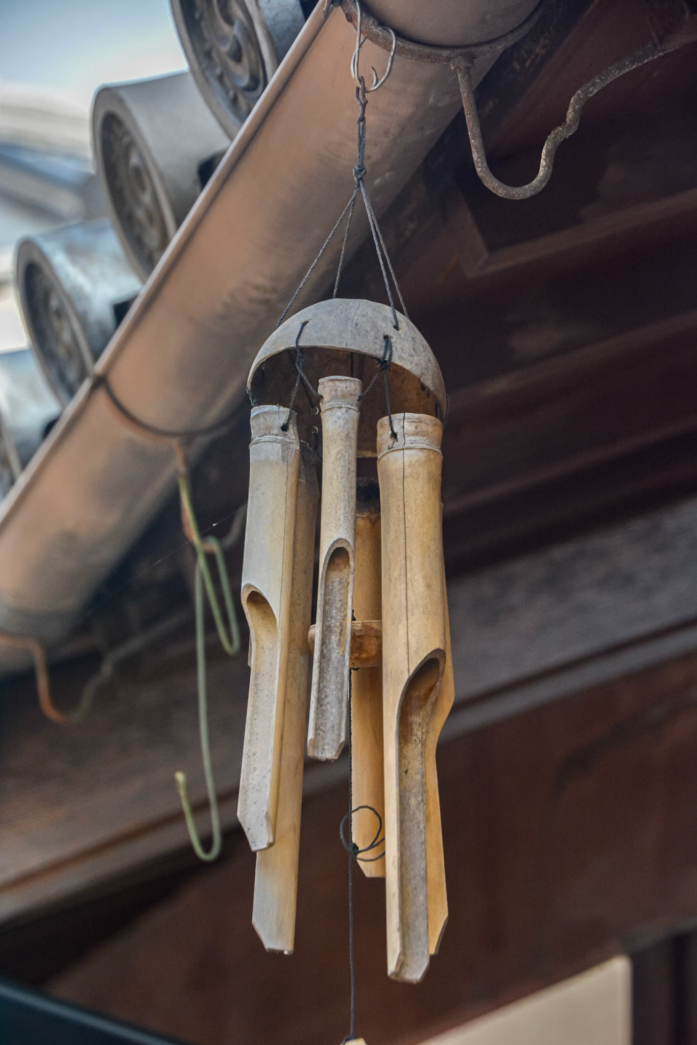 Bamboo wind chimes await a breeze.