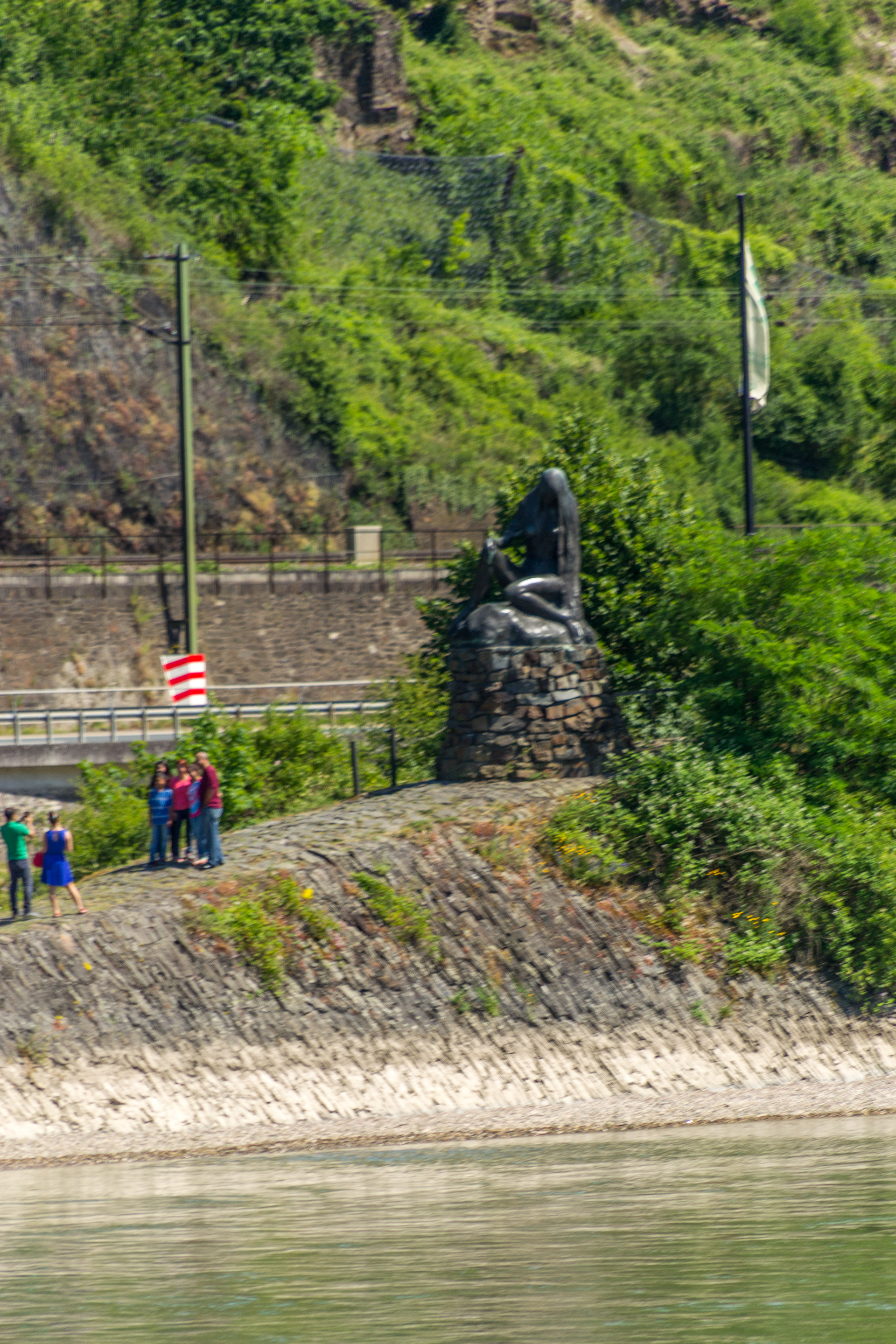 Tourists posing in front of the Loreli monument.