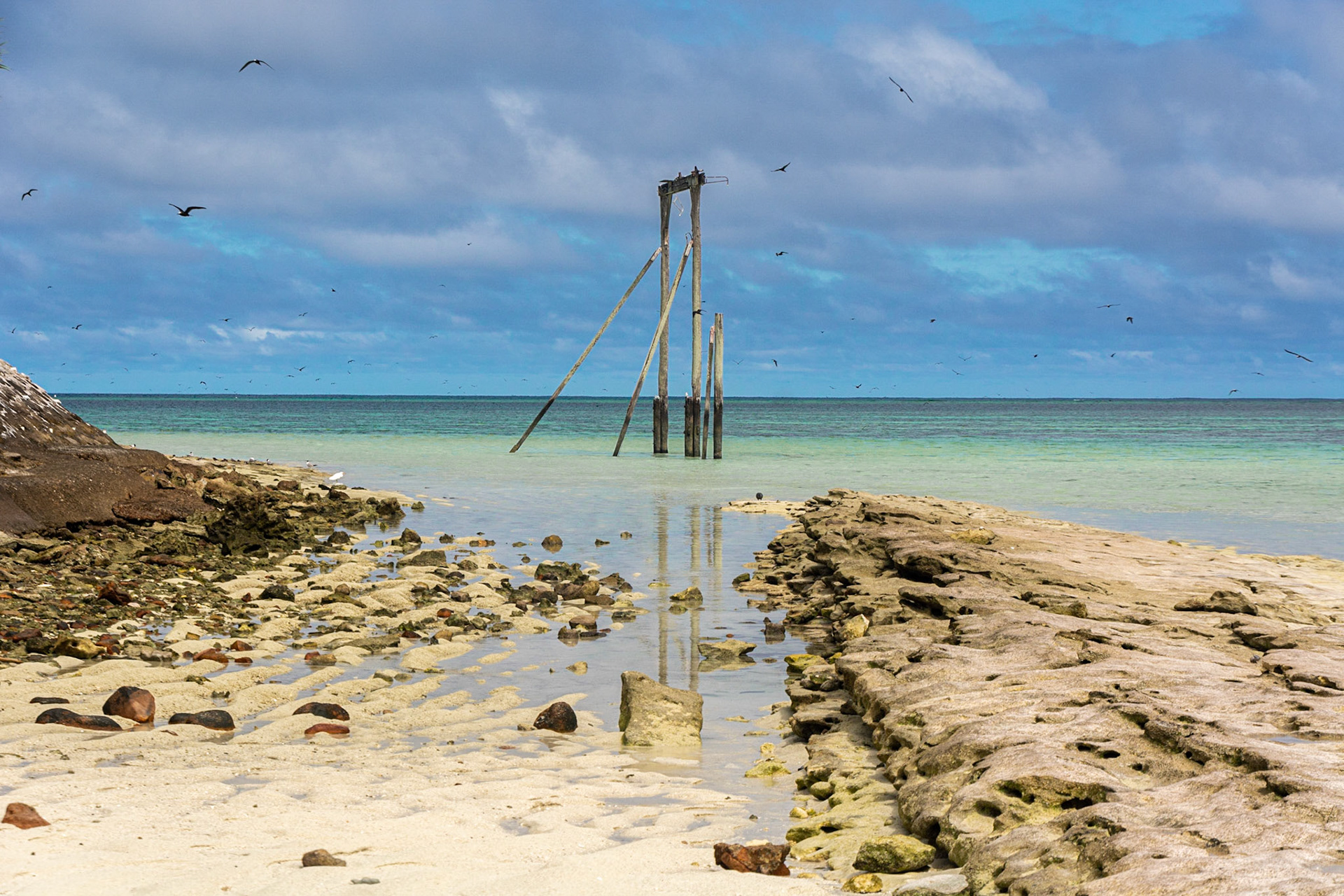 Low tide exposes the historic gantry once used to offload supplies onto the island.