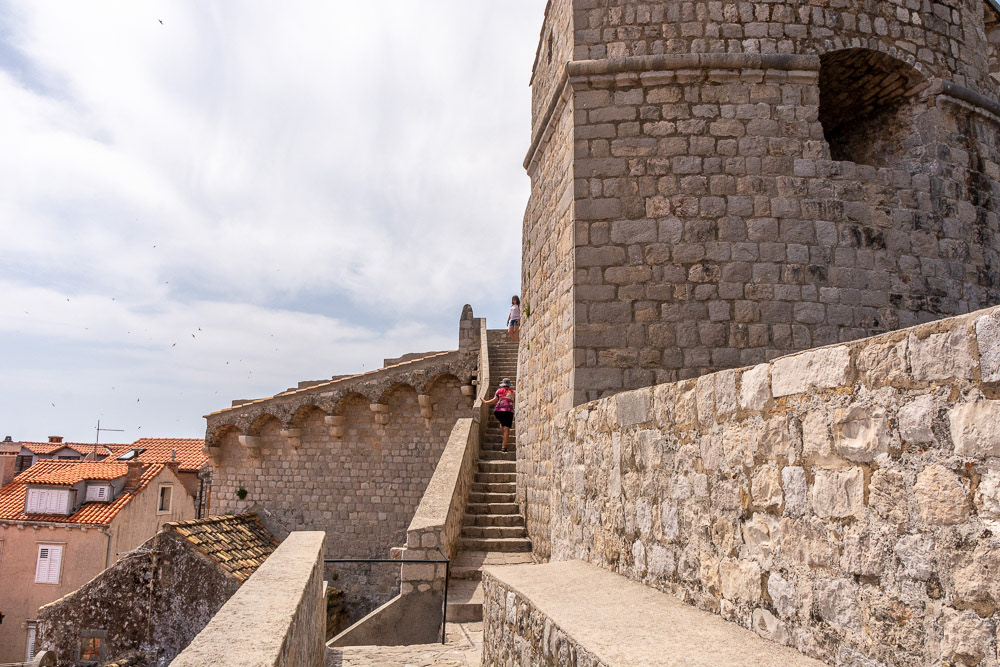 Climbing one of many flights of stairs along the wall.