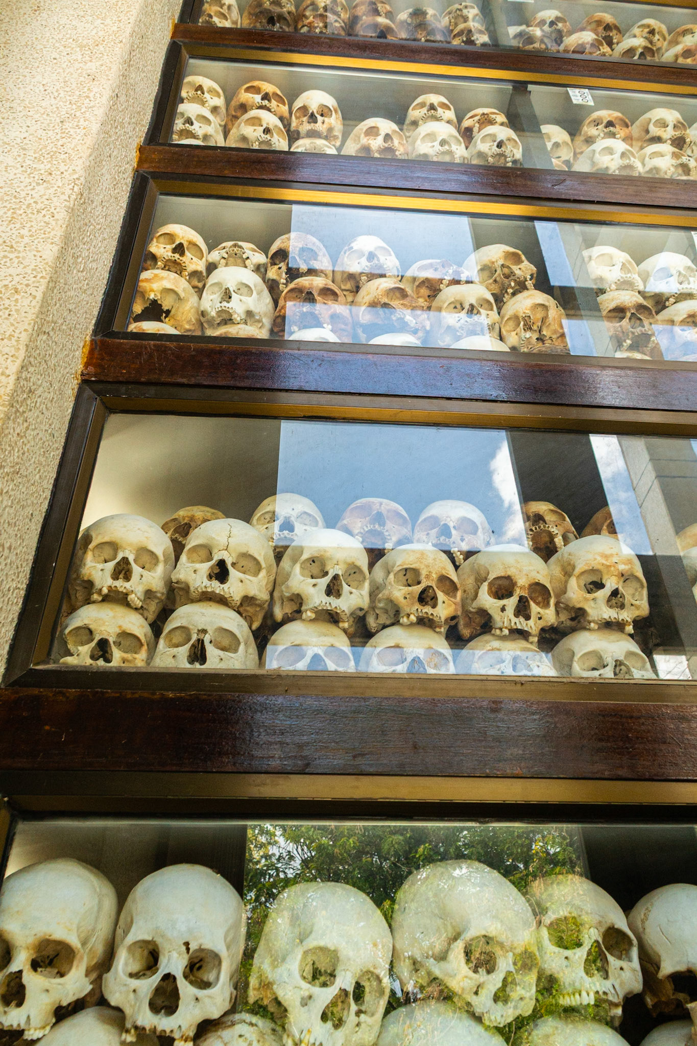 Thousands of bleached skulls lie inside the Stupa serving as a gruesome reminder of the mindless brutality of the Khmer Rouge.
