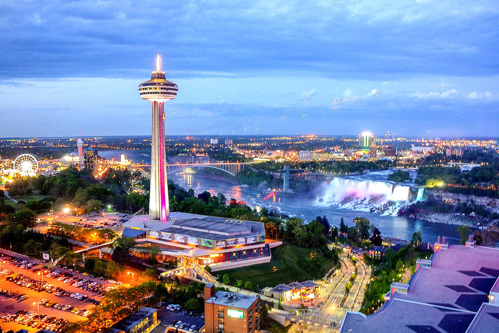 The city begins to light up with colour as evening falls.