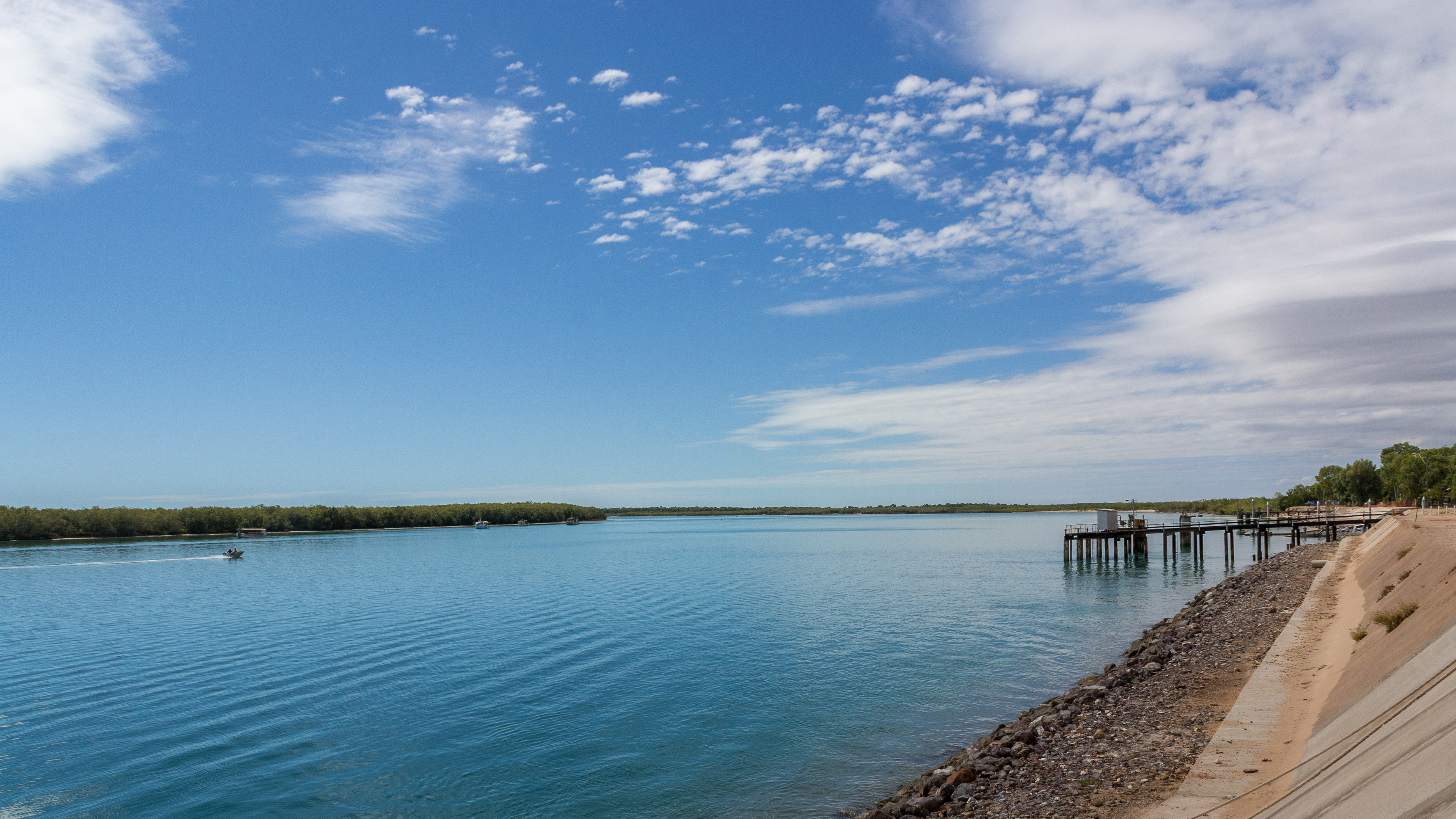 A tinny speeds past on the Norman River at Karumba.