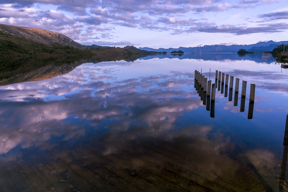 Sunset colours reflected in the mirror-smooth surface of Lake Peder.