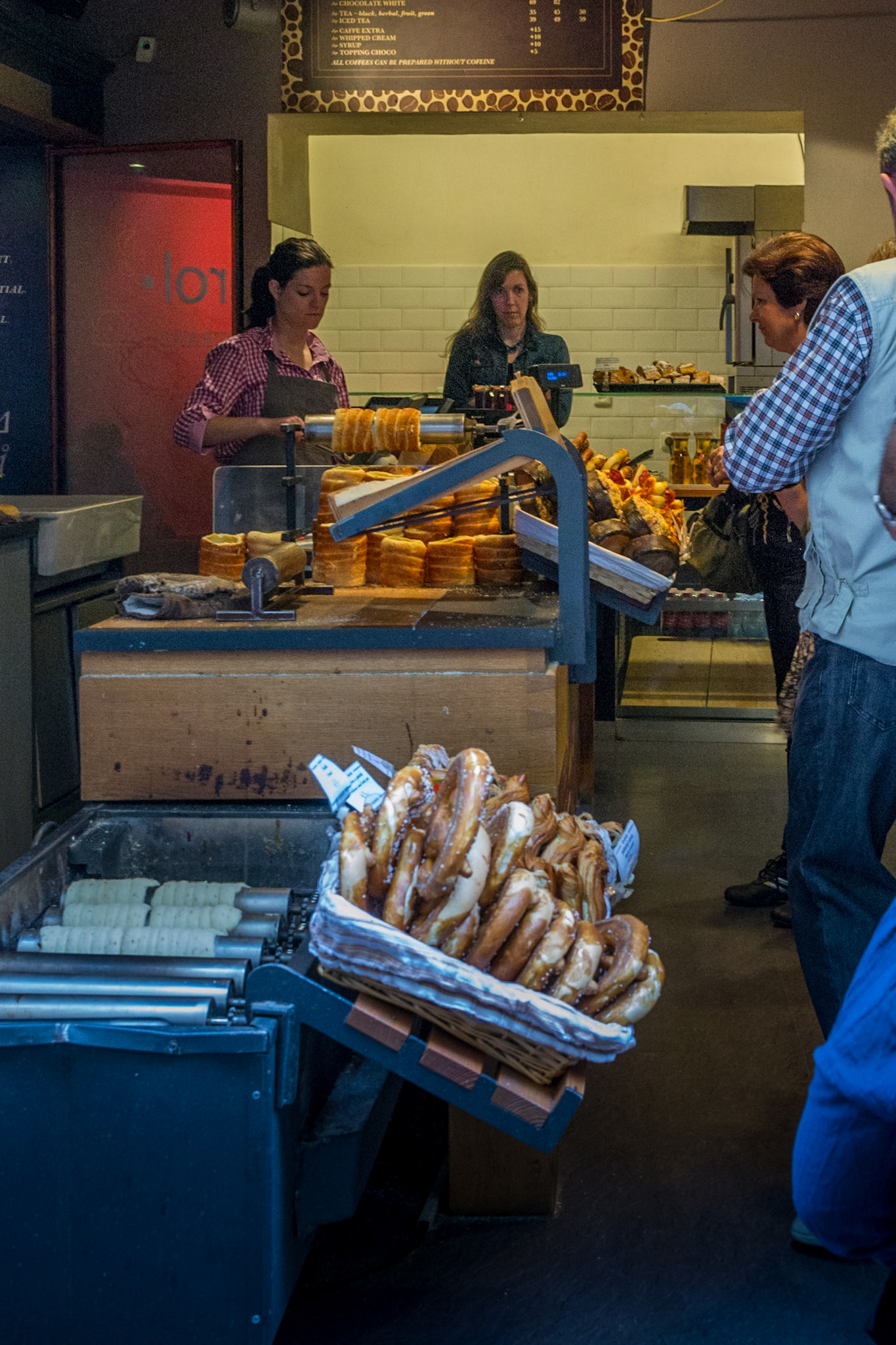 Tourists line up for Trdelnik pastry - made made by wrapping dough around a stick and roasting it over an open flame until it is golden brown and fully cooked.