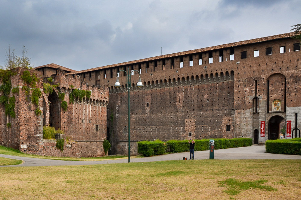 Fortified walls of the Sforzesco Castle with the Coat of arms over the entry gate.