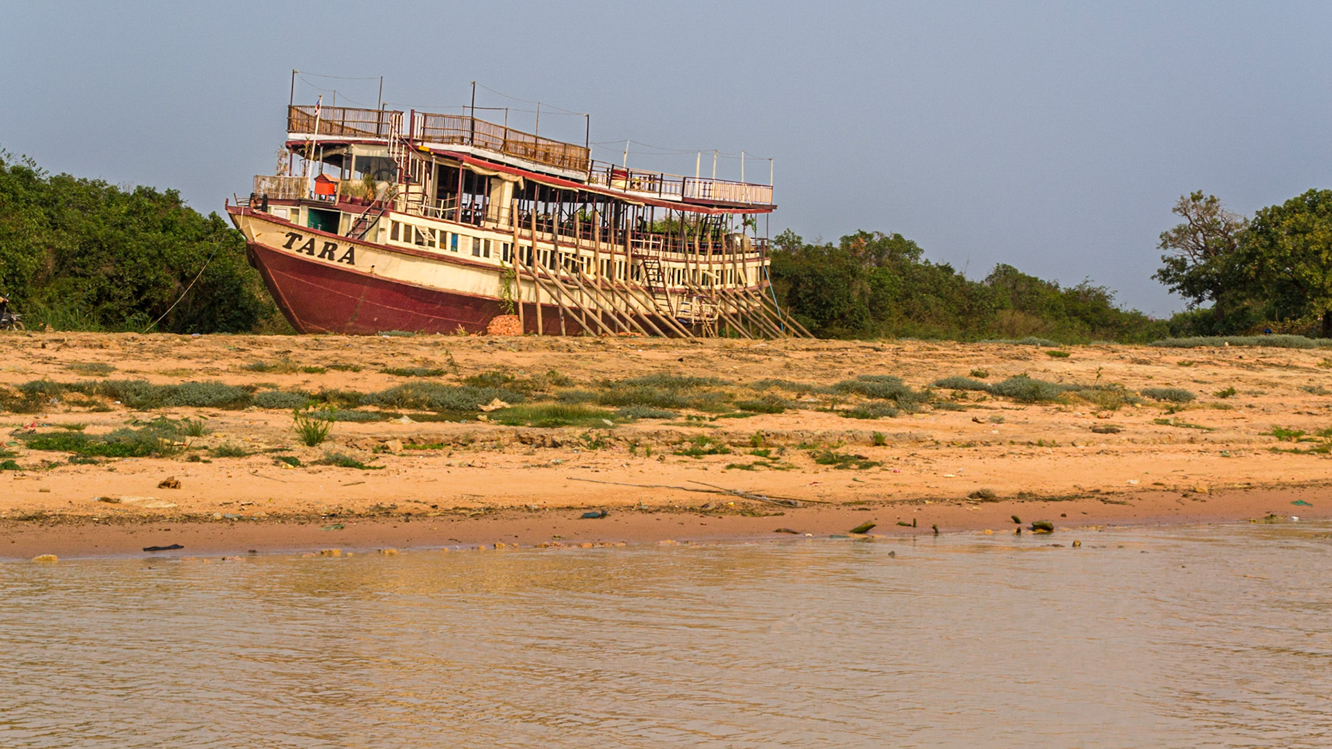 Extreme dry weather has left this large tourist boat high and dry on the riverbed far from the remaining meagre water channel..