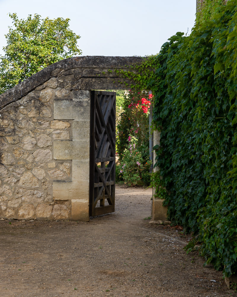 Climbing Ivy clad walls lead through the gated entry to immaculate gardens.
