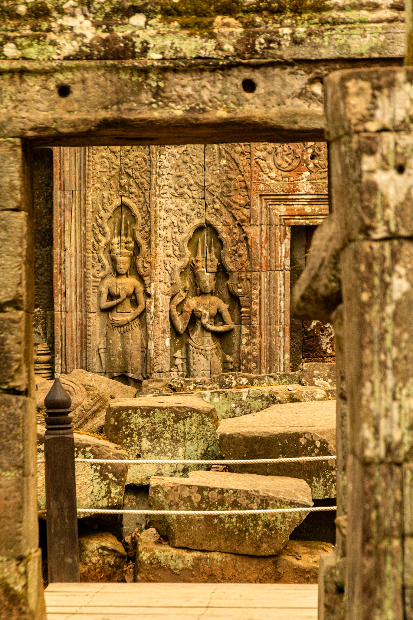 Bas relief Devas intricately carved into sandstone blocks.