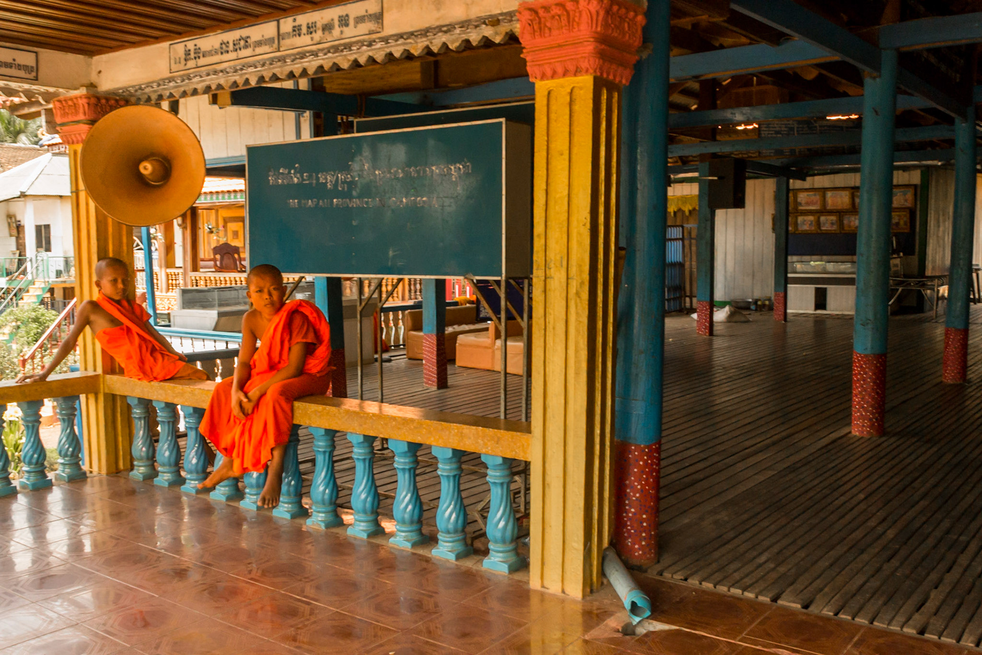 Novice Buddist Monks lounge outside the classroom.