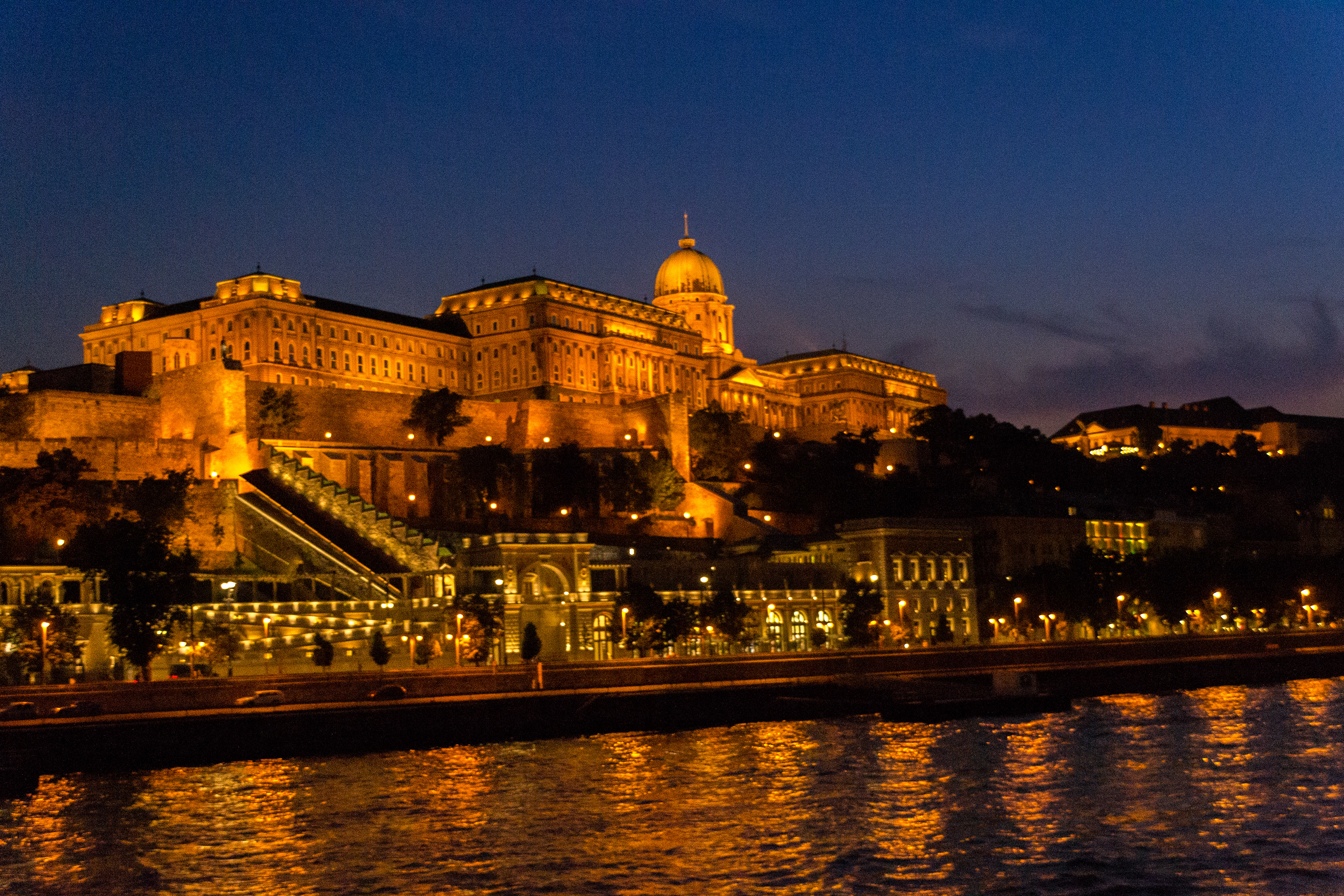 Buda Castle also known as the Royal Castle lit up against the night sky.