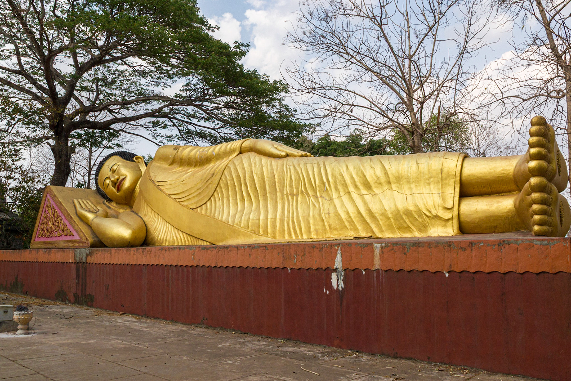 A giant Golden Buddah rests peacefully in the gardens.