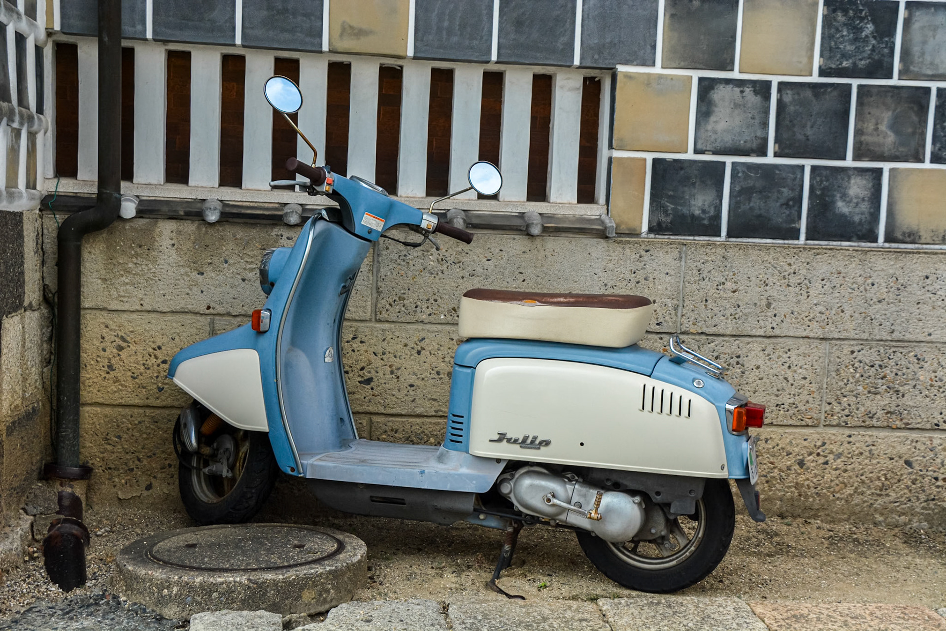A vintage Honda Julio scooter blends seamlessly within the historical district.