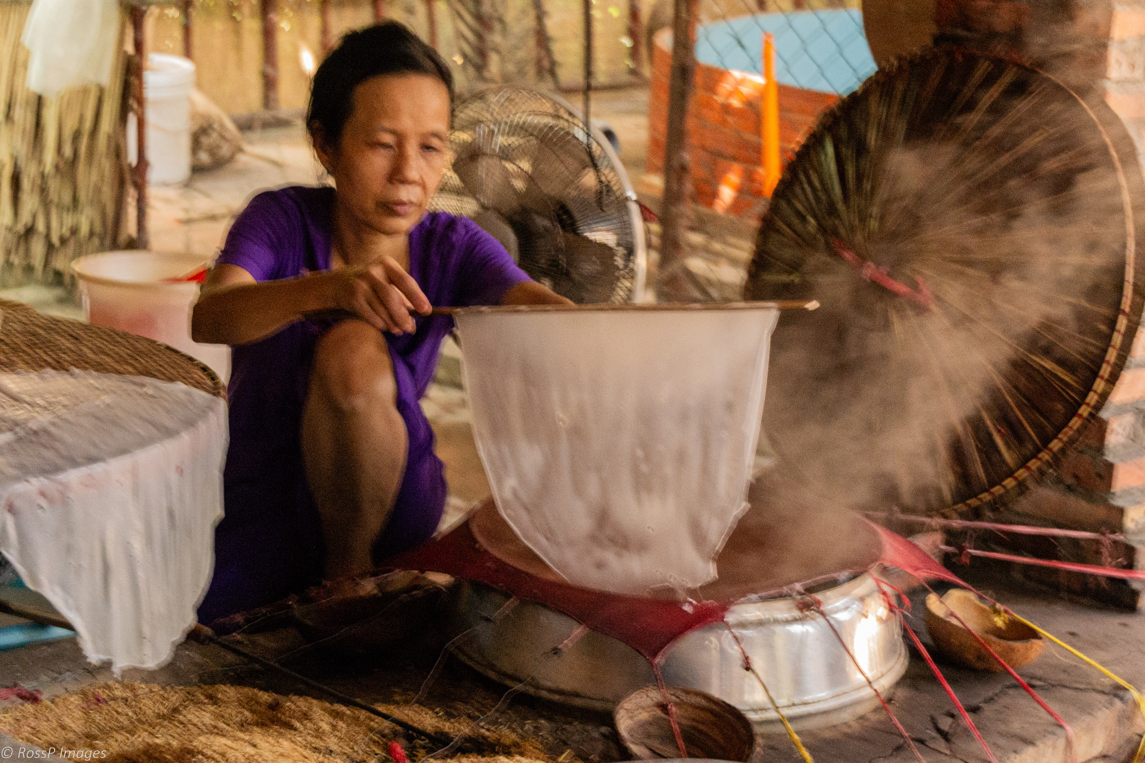 A Vietnamese woman makes rice paper at a restaurant in a Cai Be village.