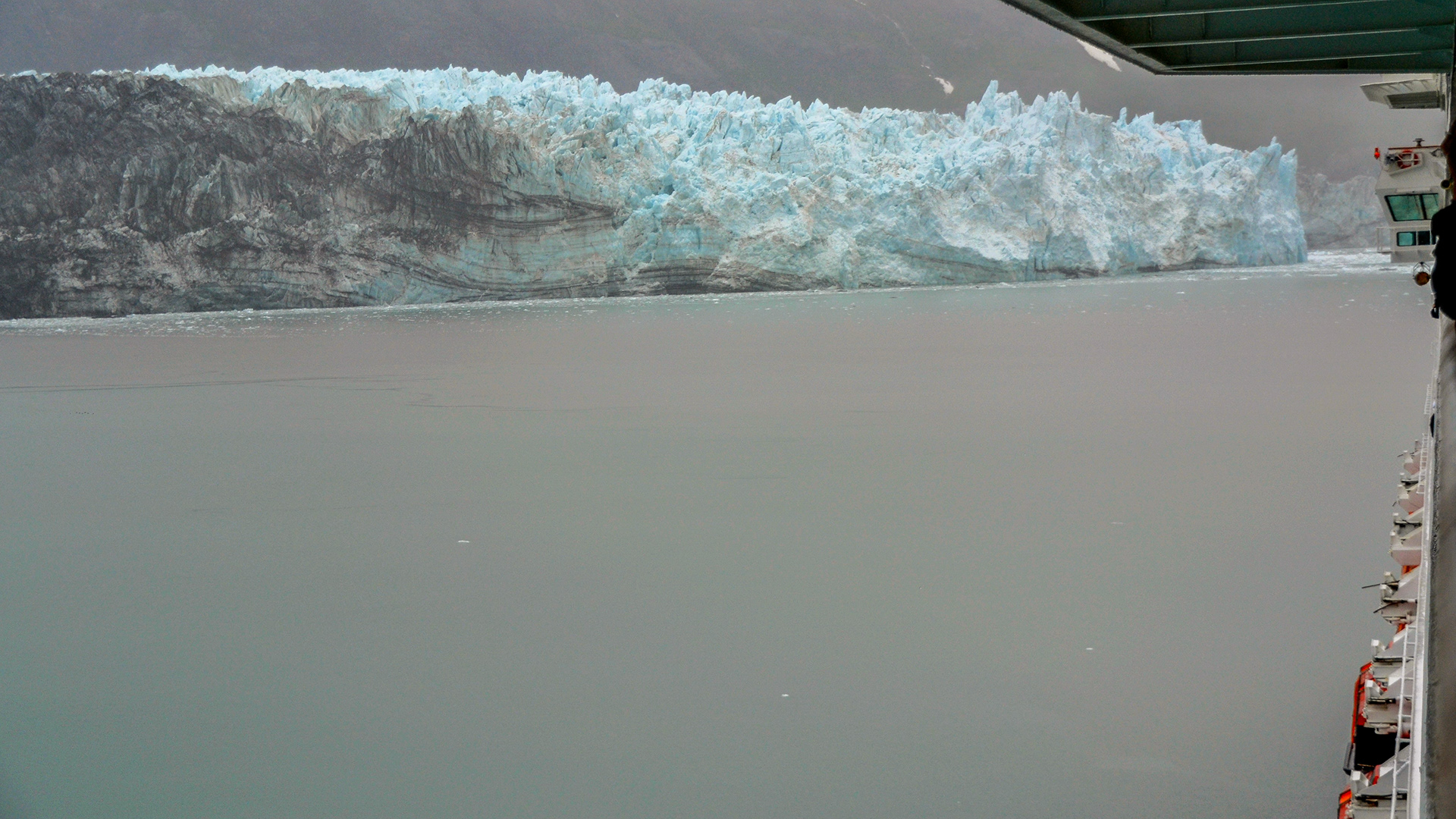 The grandeur and scale of Margerie Glacier's snout is demonstrated as it towers above our cruise ship.