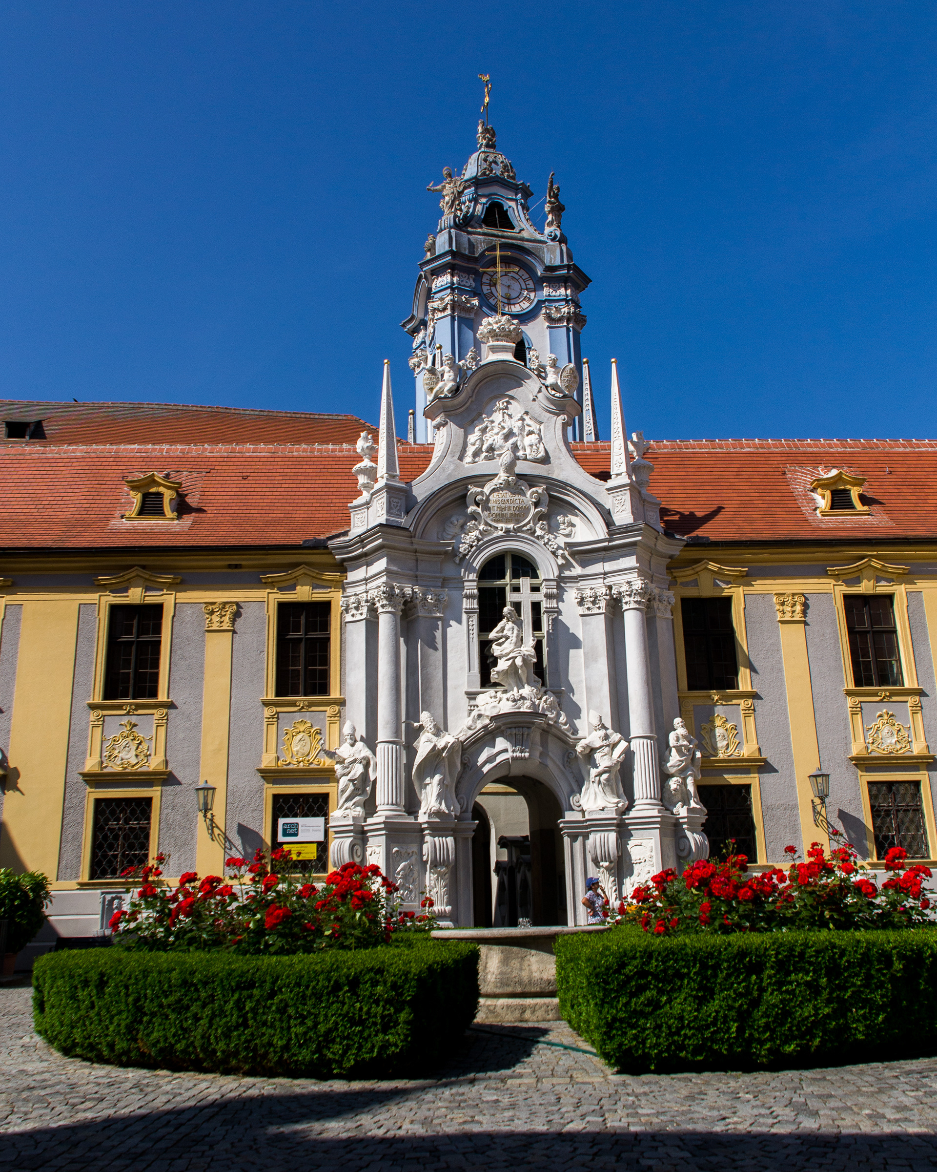 The spectacular Baroque entrance to the Augustine Convent with the Churche's blue bell-tower in the background.