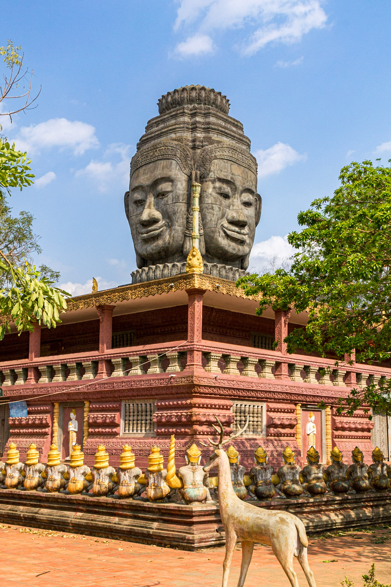 A Bayon-style head sits atop the library at Wat Phnom Pros Pagoda.