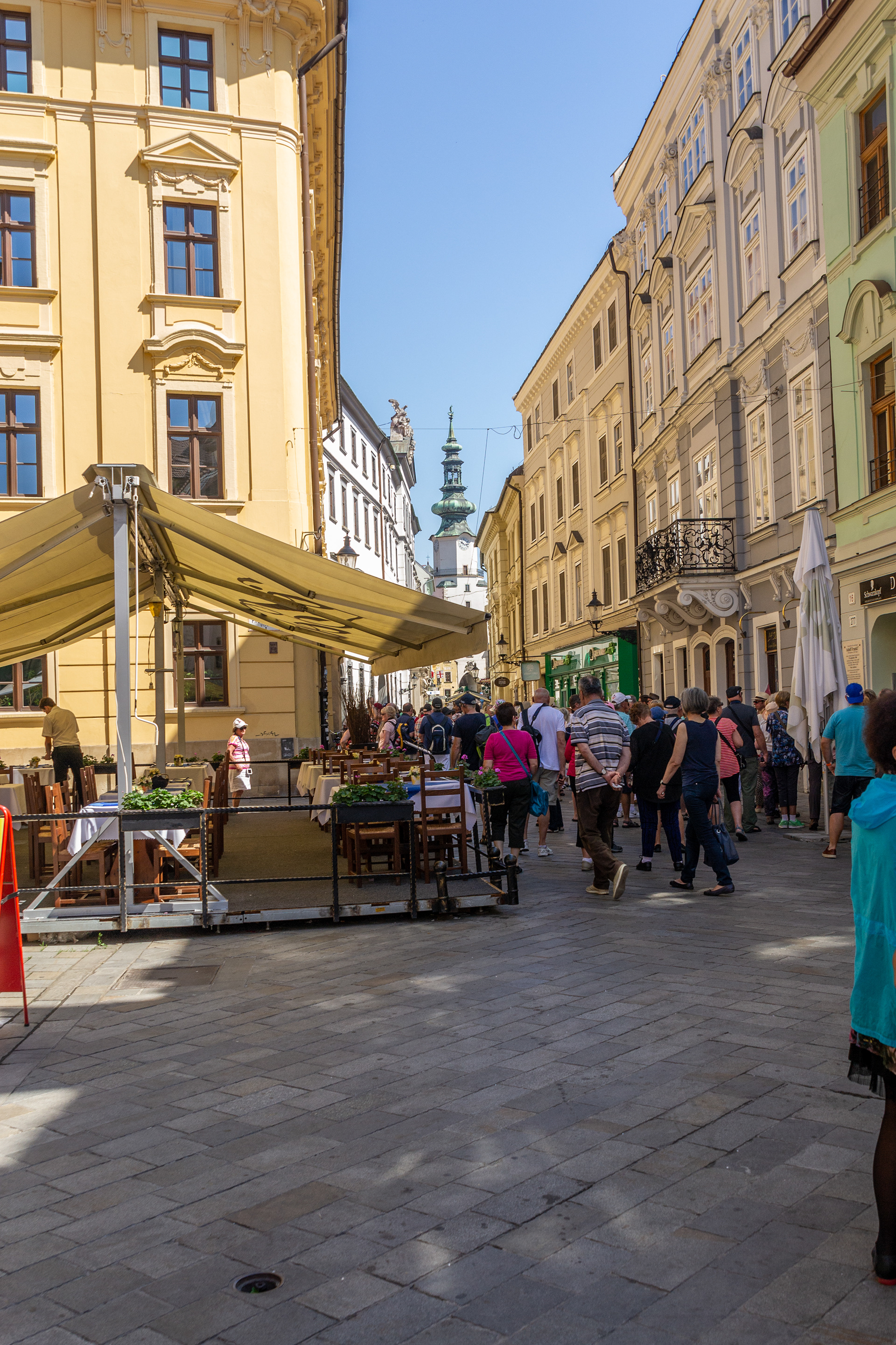 Narrow streets leading us towards Hlavne namestie, Bratislava's main square. The Town Hall's tower looms at the end of the laneway.