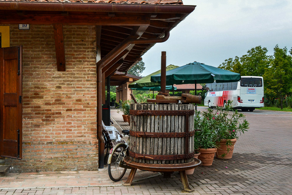 An old wine press displayed proudly beside the main entry, a reminder of the family's past traditions.