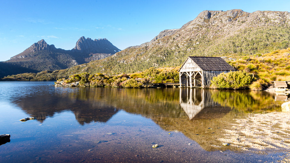 Dove lake boathouse with Cradle Mountain in the background on a crisp morning.