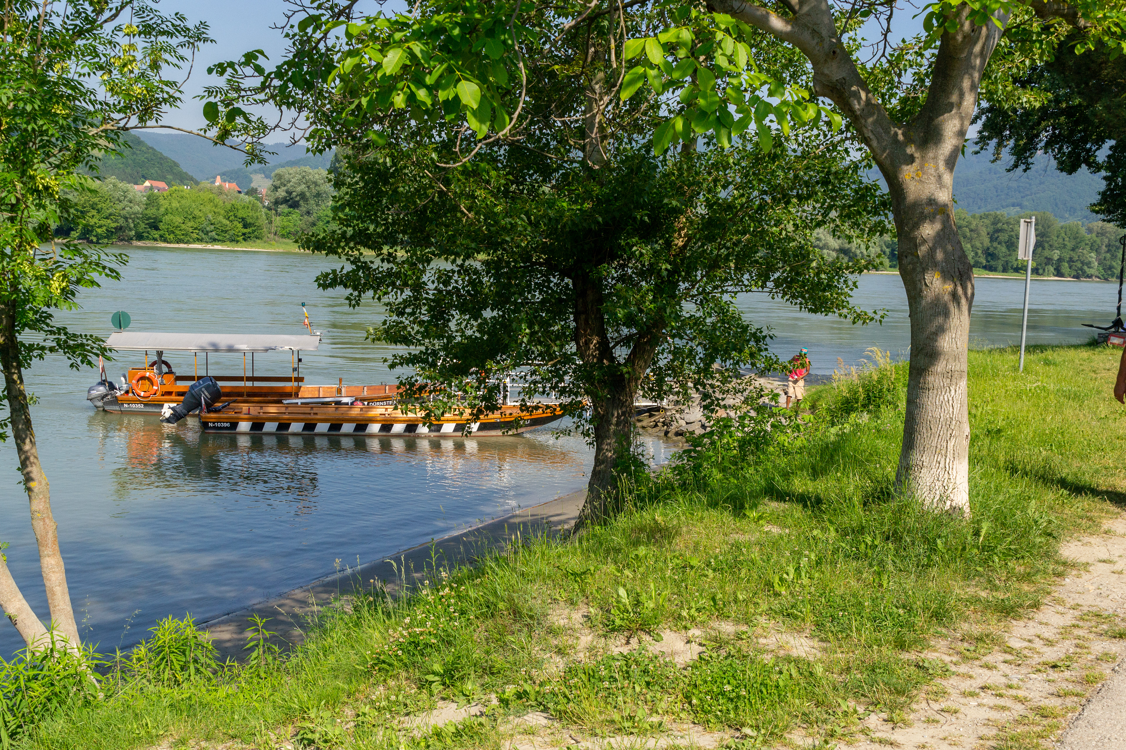 Local river ferries moored on the riverbank.
