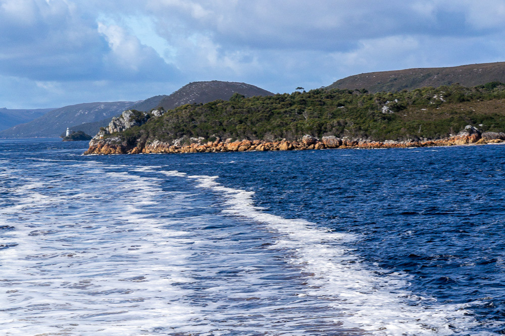 Hells Gates, viewed from the ocean side of the entrance. Entrance Island is on the left. Bonnet Island lighthouse is visible in the distance.
