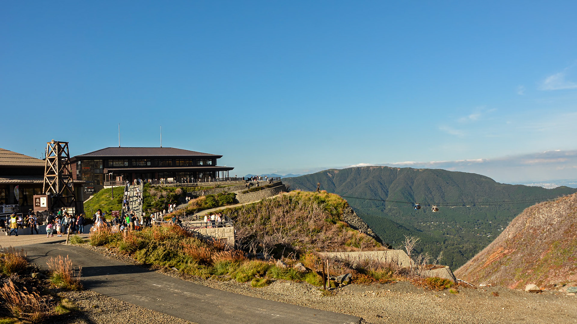 Hakone Ropeway station with cable-cars transiting over the valley below.