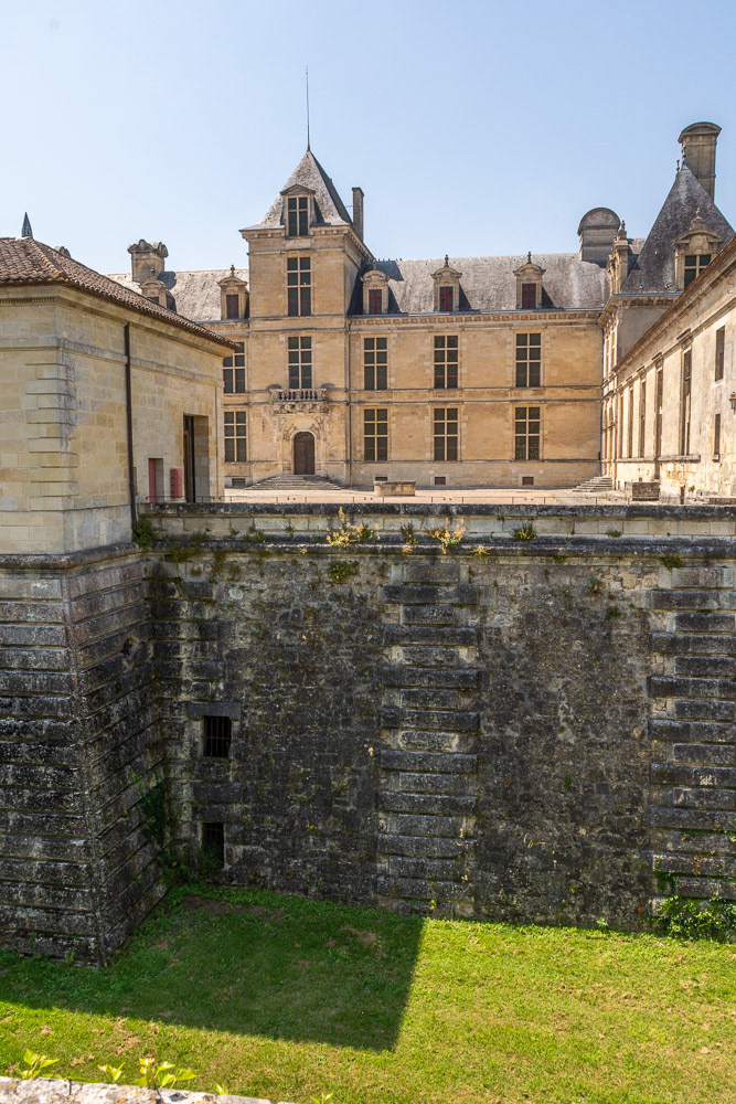 Château des ducs d'Épernon surrounded by moat.