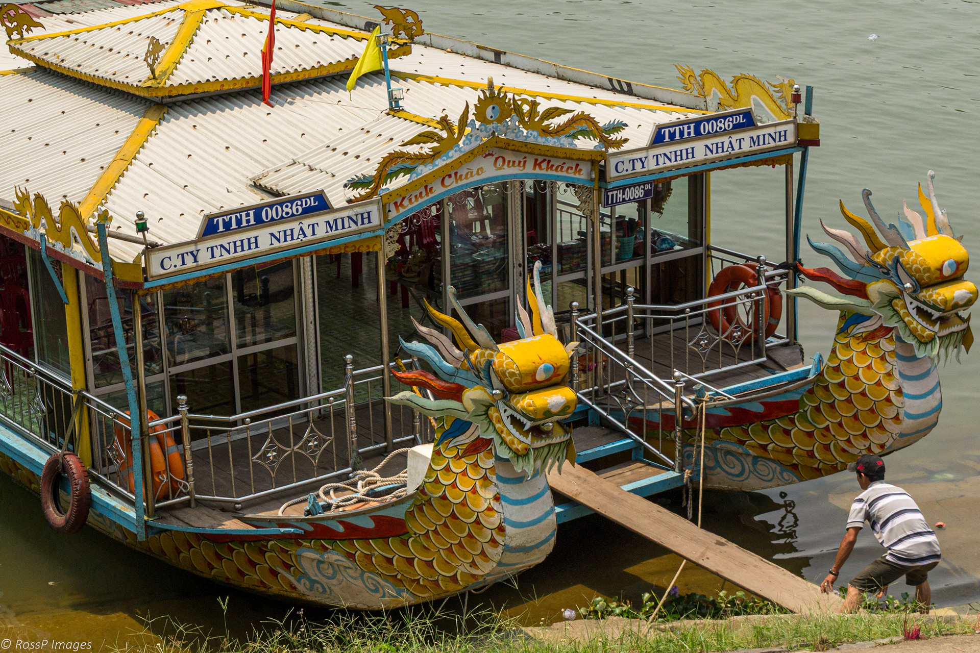 Preparing a Dragon Boat for tourist trips on the Perfume River. The boat is home to the family who operates them.