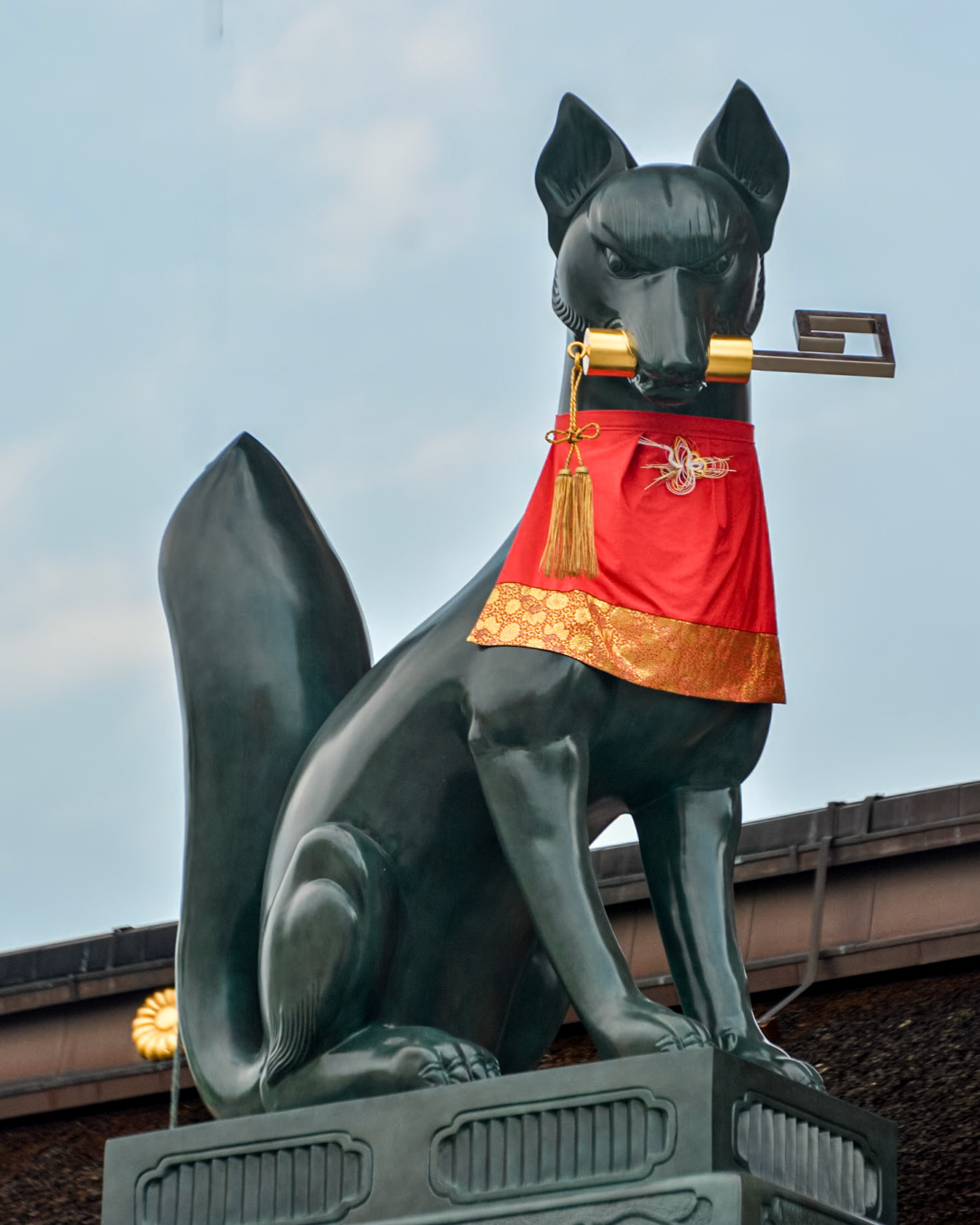 Fushimi Inari-Taisha Shrine - near the main gate is a fox holding a key in its mouth.