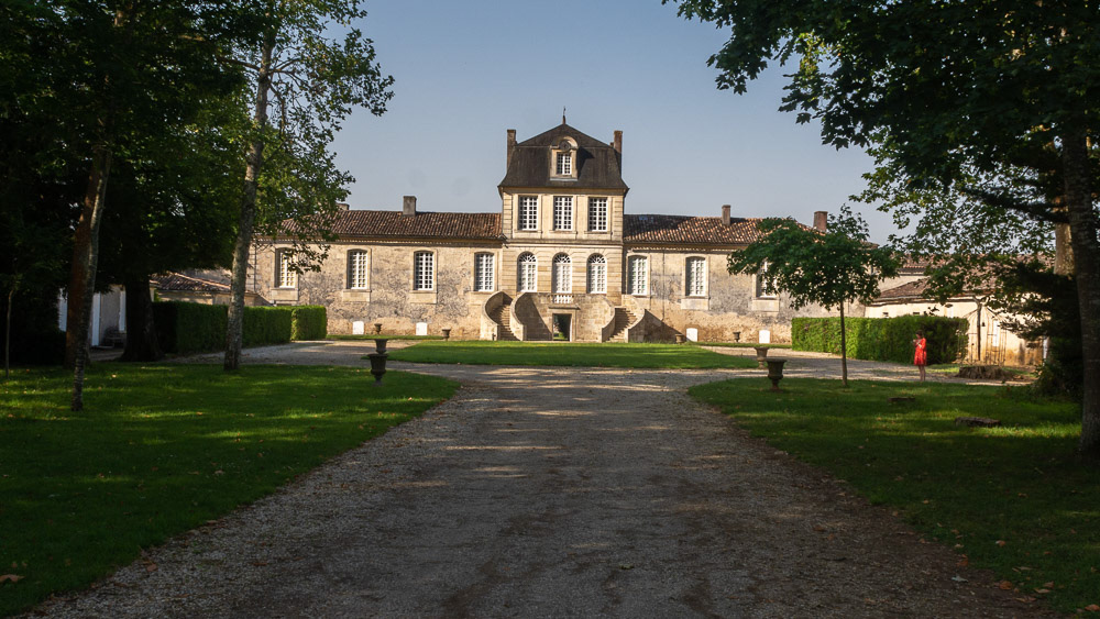 Chateau de Myrat, Saturnes emerges ahead of us from the shaded driveway.