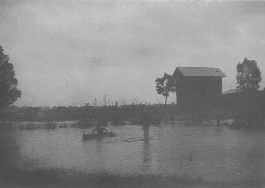 Floodwater deep enough to paddle a canoe in front of the farmhouse.