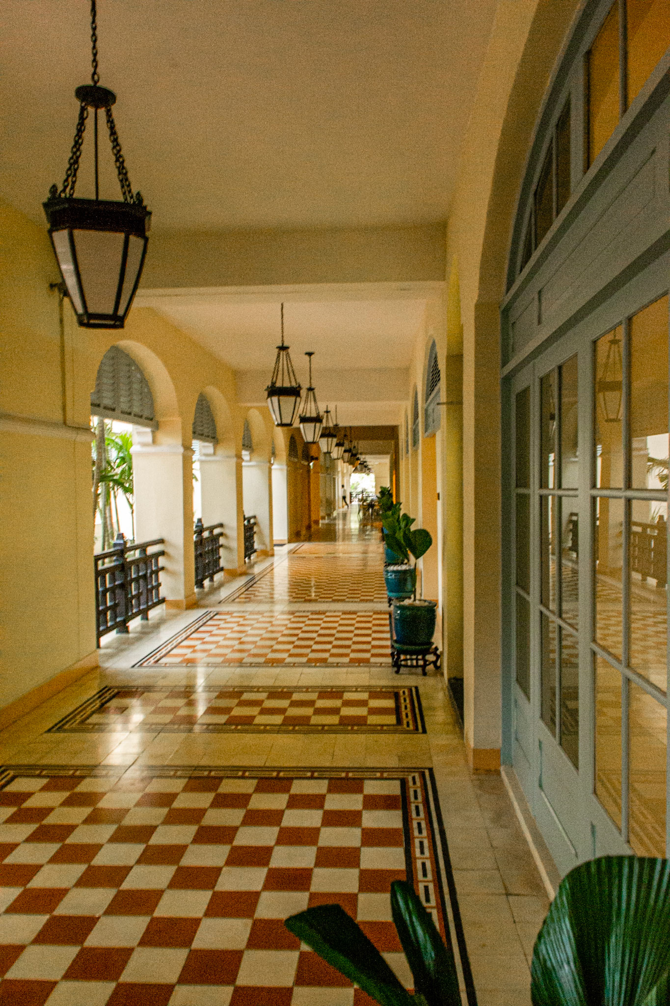 The shaded verandas of Raffles Le Royal provide welcoming respite from the afternoon heat.