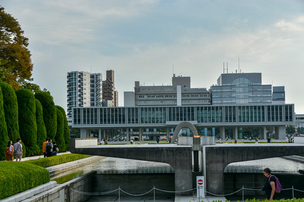 Peace Flame in alignment with the cenotaph and with the Peace Memorial Museum in the background.