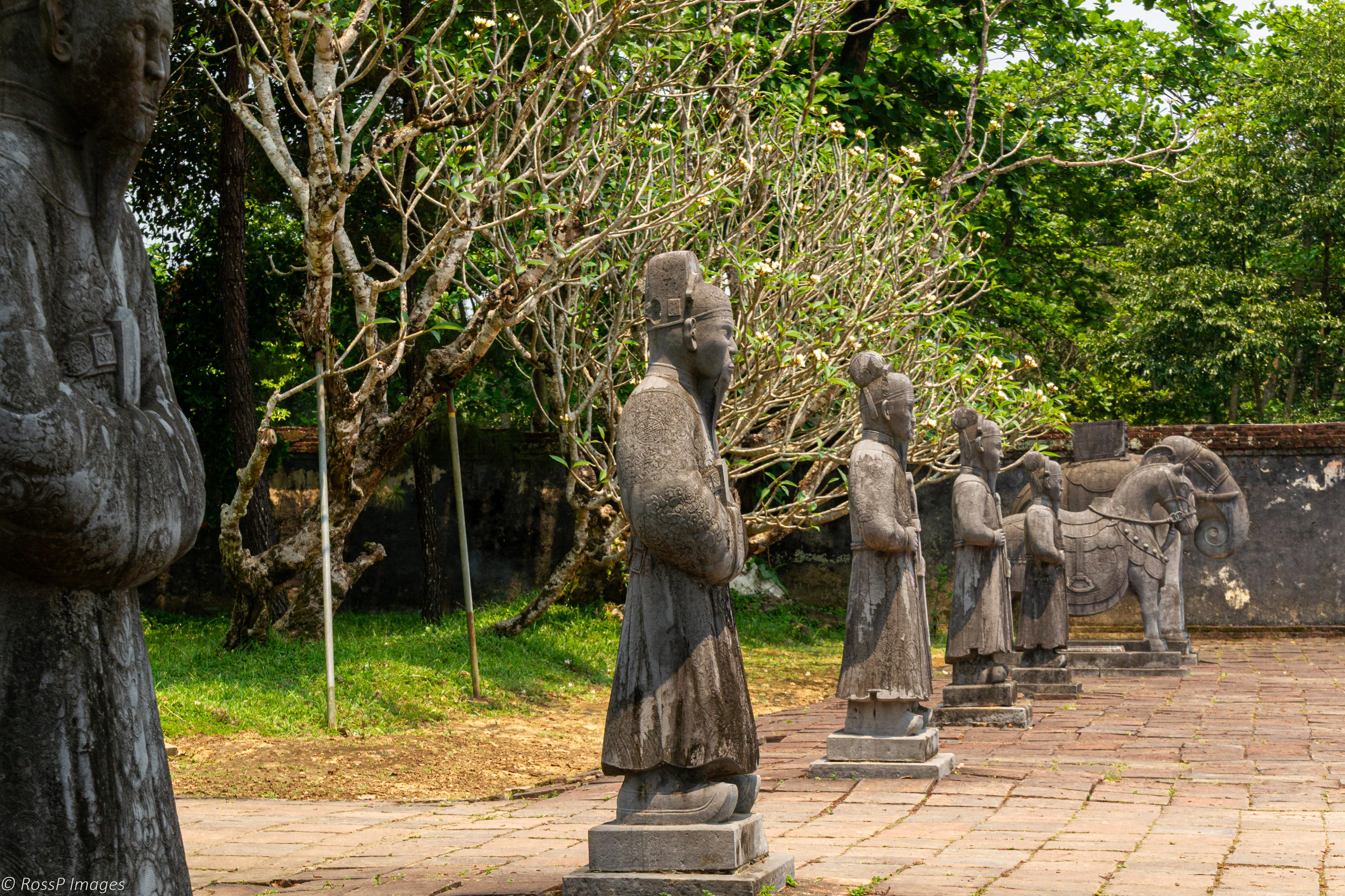 Stone carvings of Mandarins and war horses and elephants form a guard of honour entering Emperor Minh Mang's Tomb.