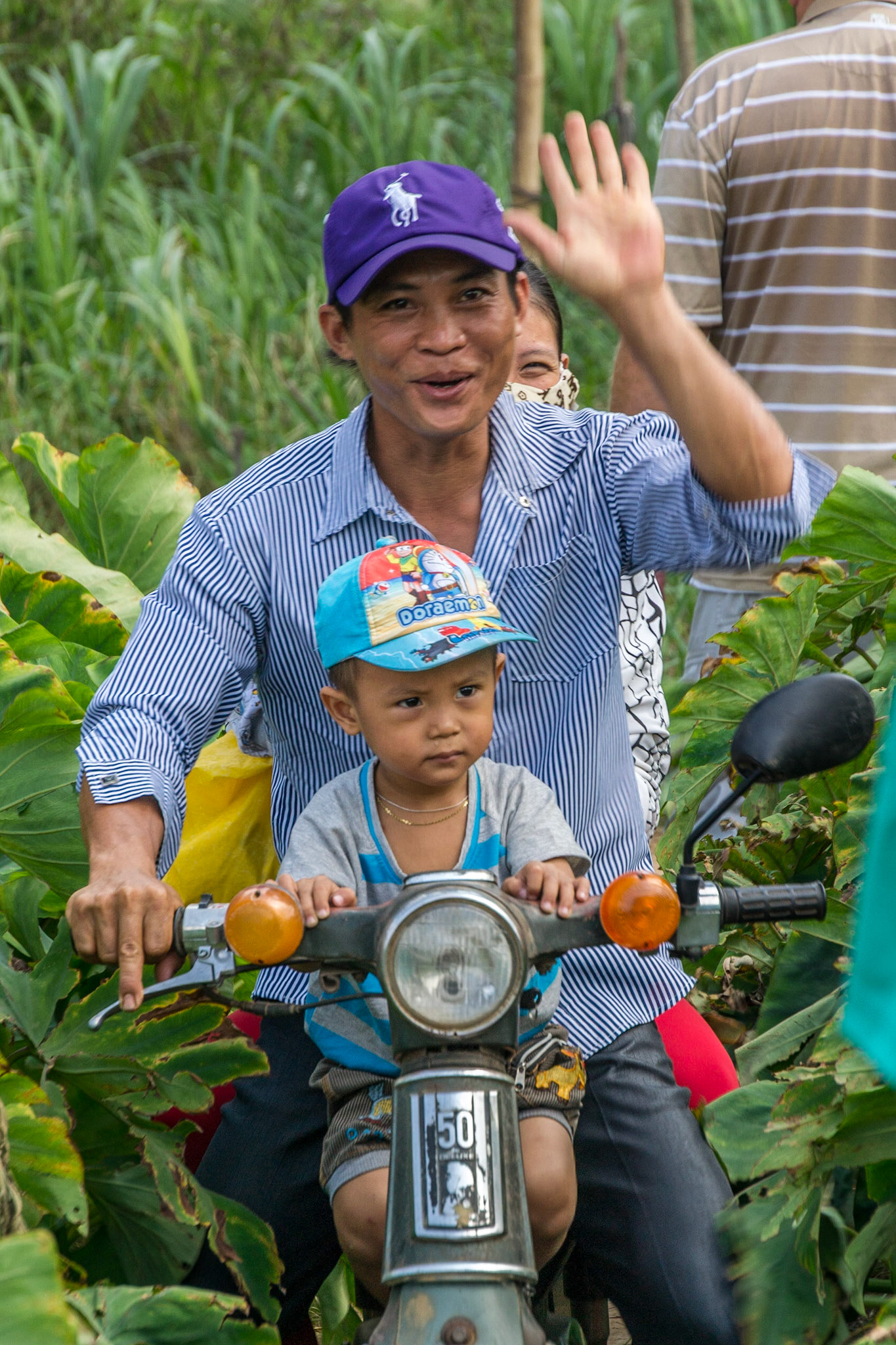 Hi-five as we share a single-lane path through the fields with the locals.