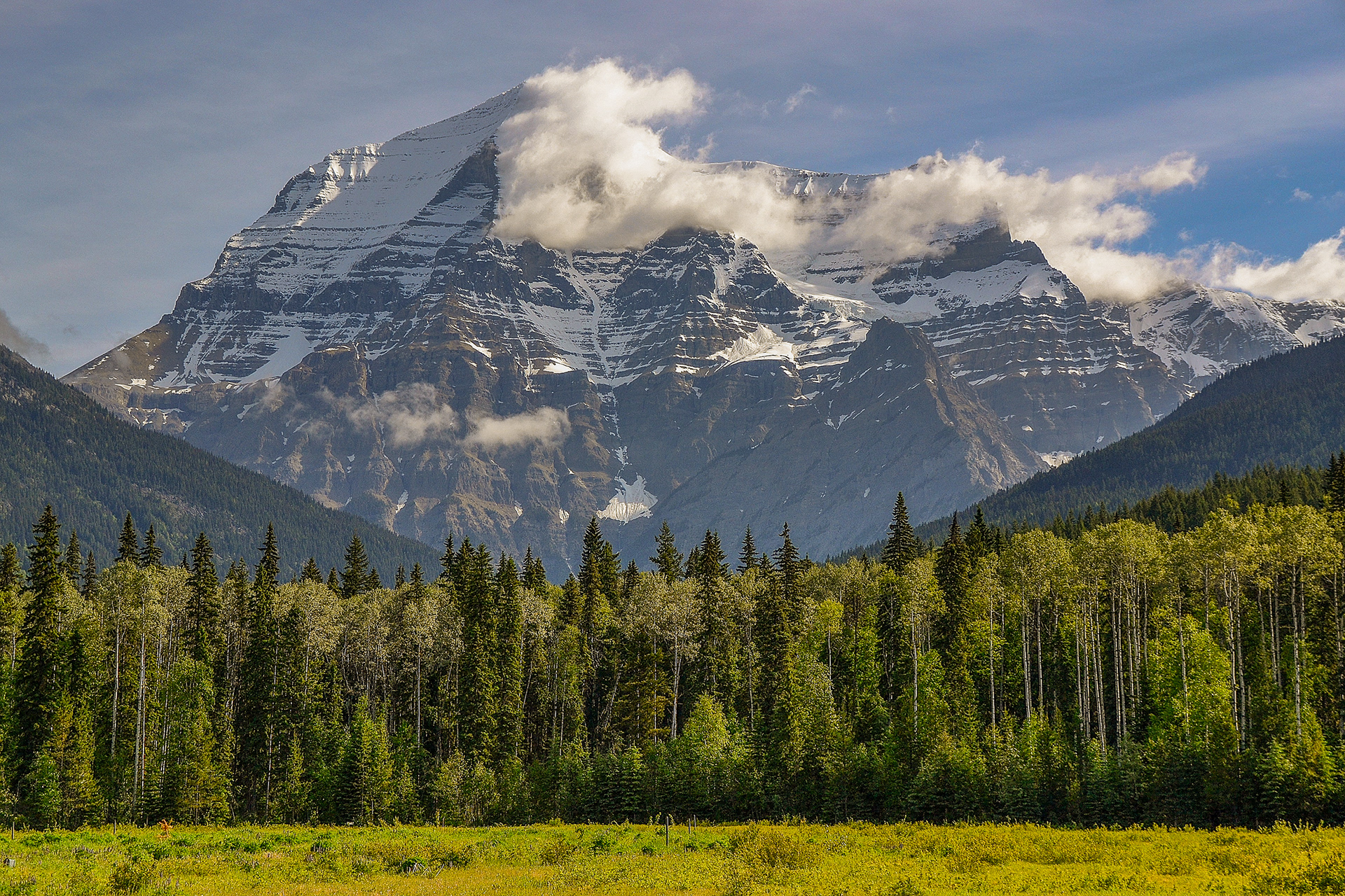Mt Robson the highest point in the Canadian Rockies. High winds cause clouds to form in the lee of its snow capped peak.