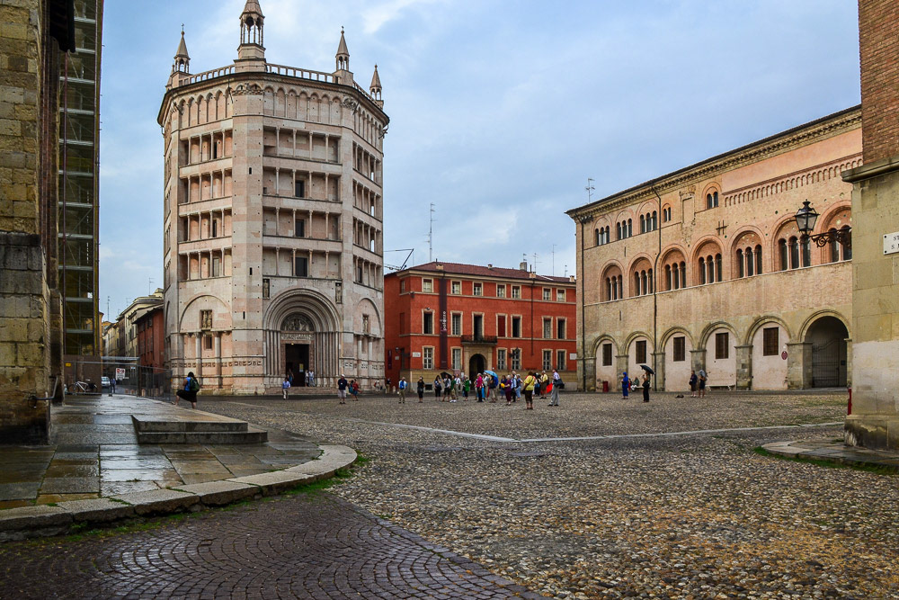 Parma Baptistery towering over the surrounding buildings, including the cathedral next door.