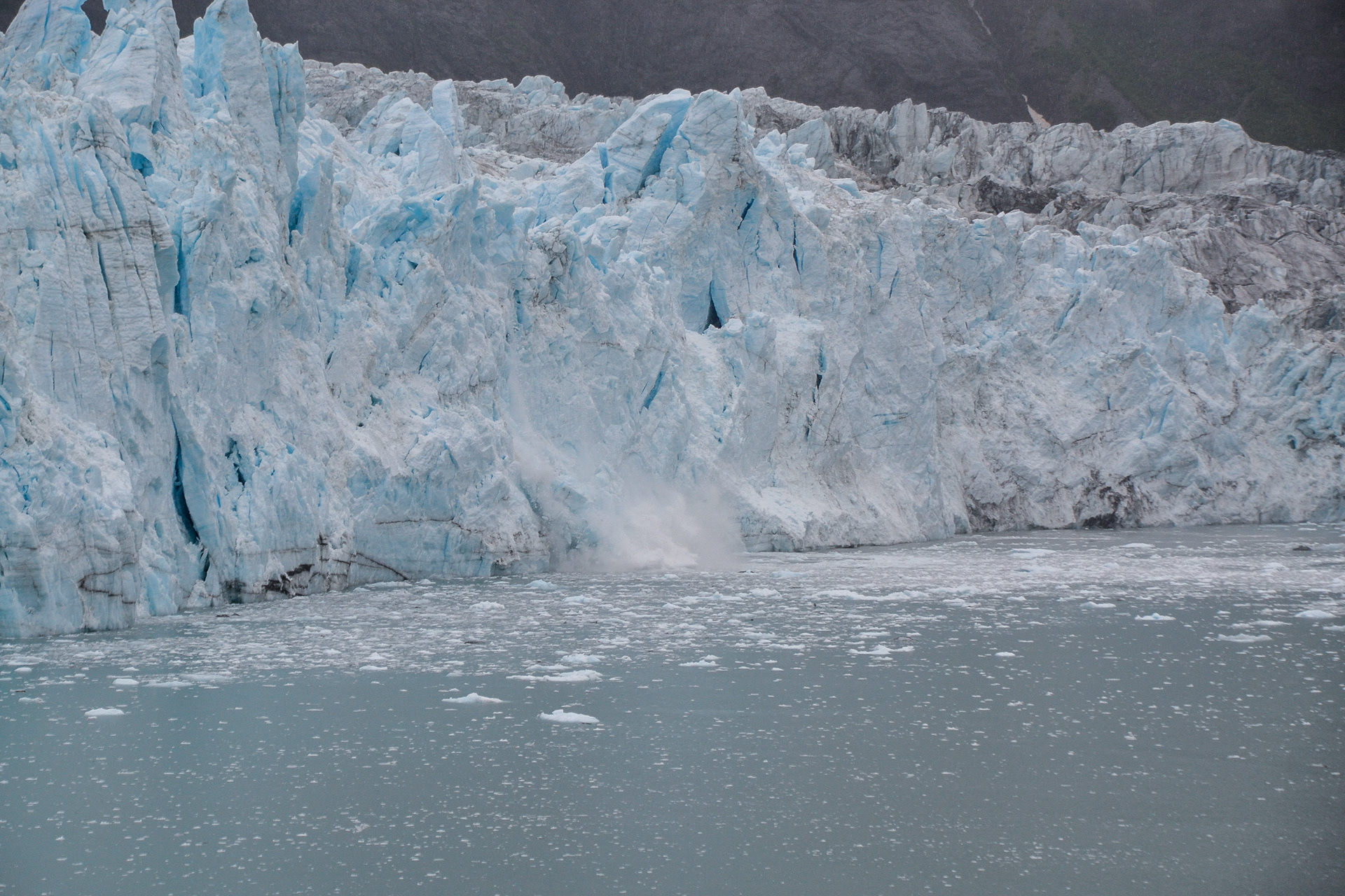Three frames capture a brief moment in time as a huge section of ice calves from the face and crash into the sea..........