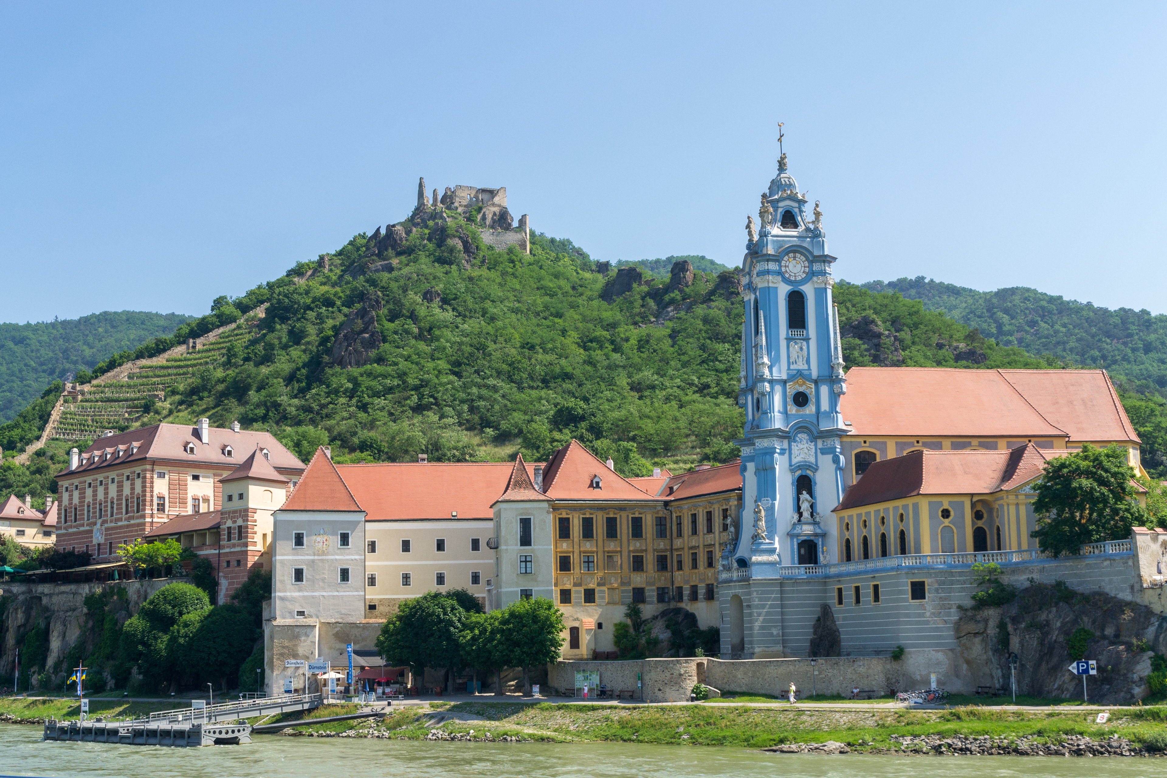 The Augustinian Abbey Church's blue Baroque bell-tower on the bank of the River Danube with the Kuenringerbuig fotress ruins above, arguably one of the most famous of images in the Wachau region of Austria.