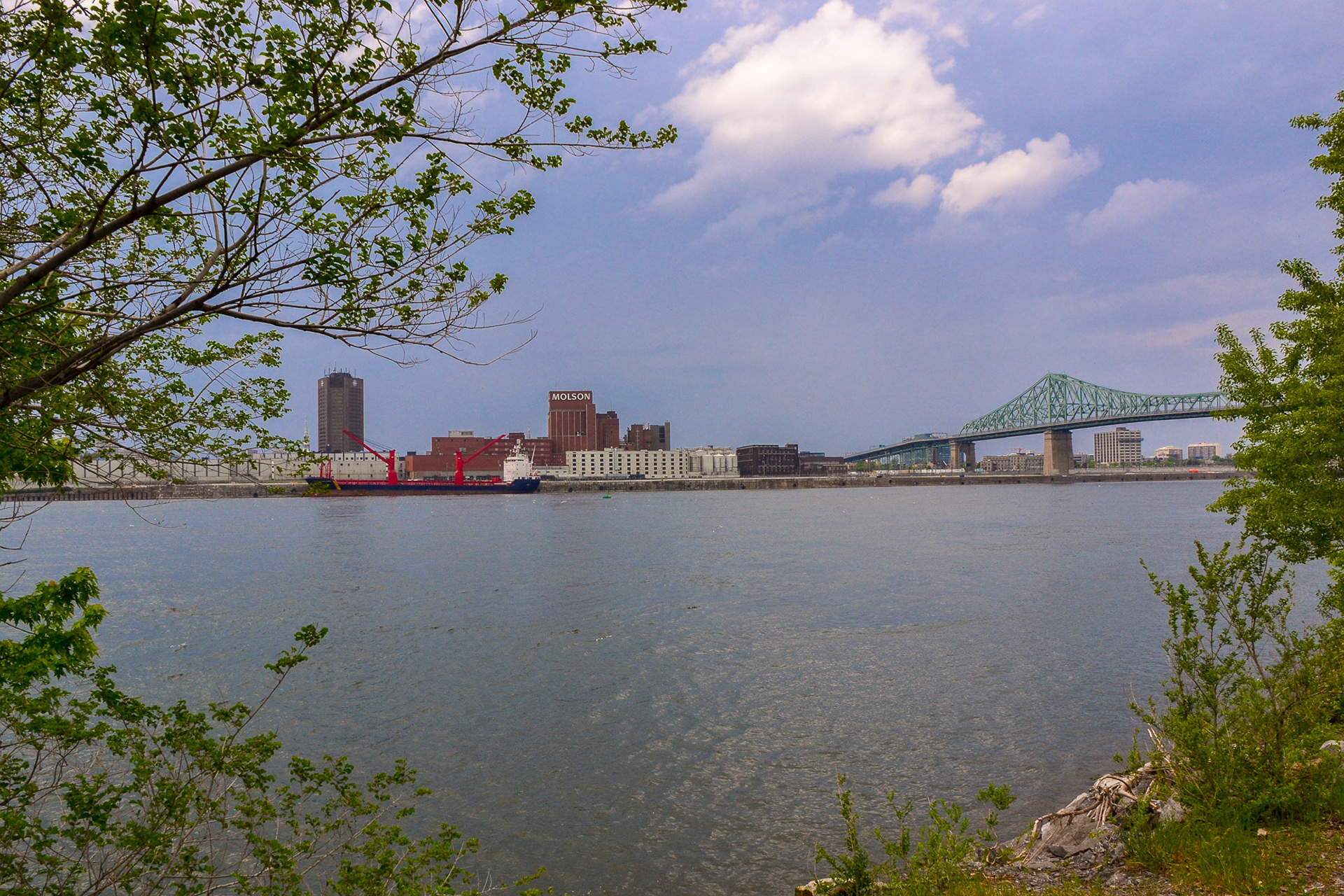 A view over the St Lawrence River with the Jacques Cartier bridge and a storm brewing in the background.