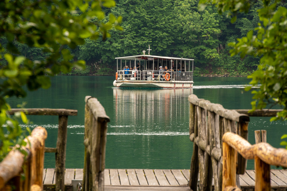 A barge approaches the lakside landing to transport groups across the lake.