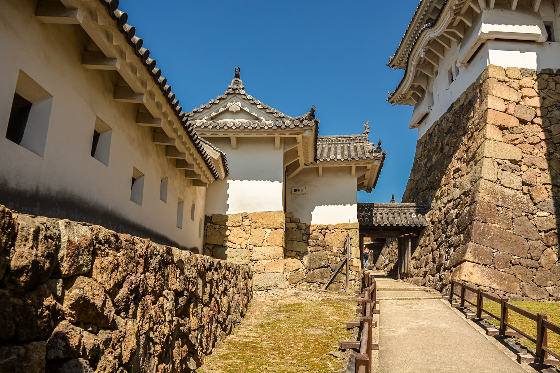 One of the steep, narrow walkways controlling access to the castle featuring angled chutes or "stone drop windows" above.