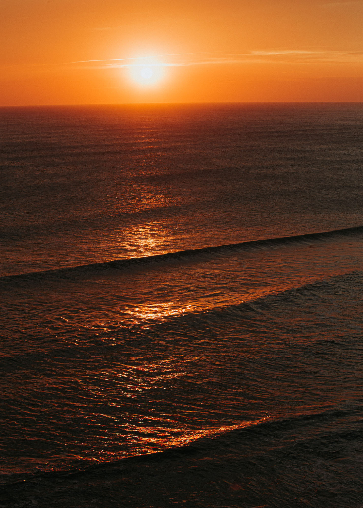 Sunset across the sets of waves at Mahia's Blacks Beach